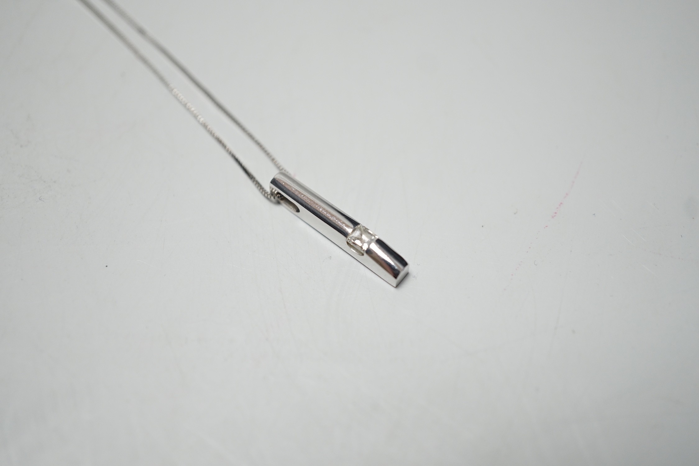 A modern 18ct white gold and solitaire diamond set pendant, 22mm, on an 18ct white gold fine link chain, 46cm, gross weight 4.1 grams.